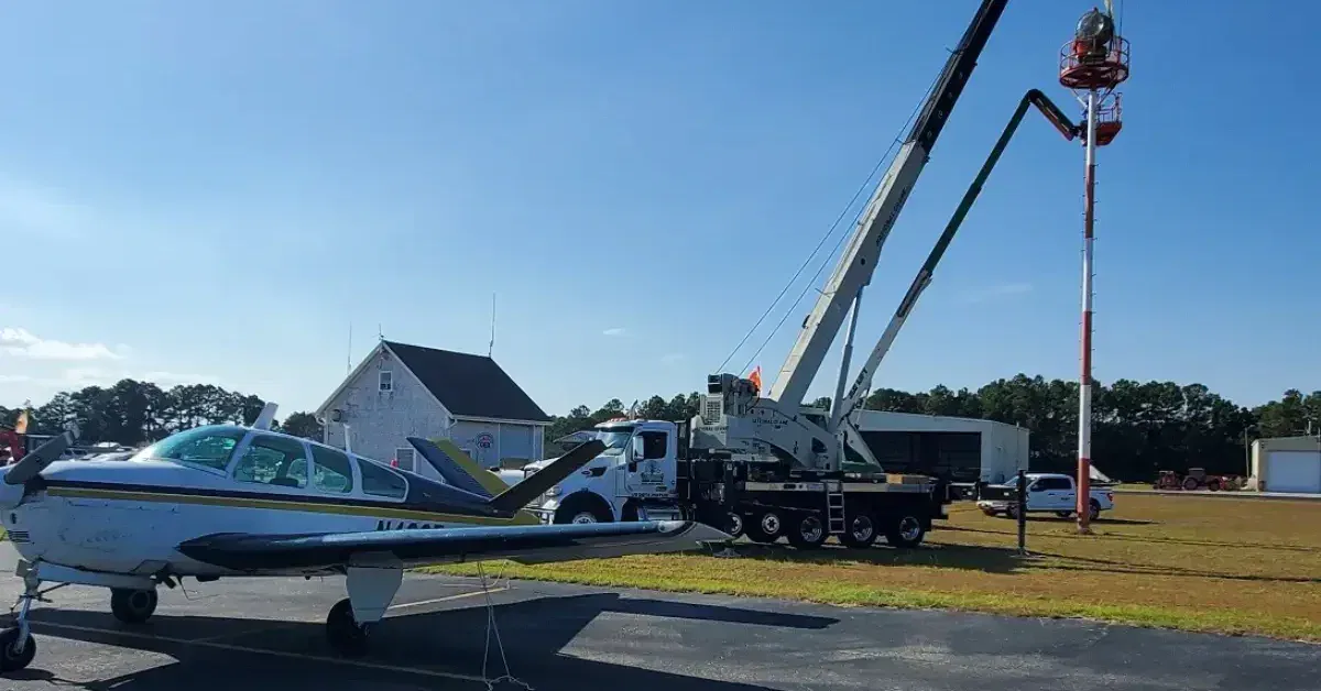 Crane rental in Kitty Hawk, NC, lifting HVAC unit in coastal residential area