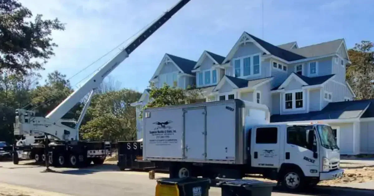 Crane rental in Coinjock, NC, lifting HVAC unit in coastal residential area