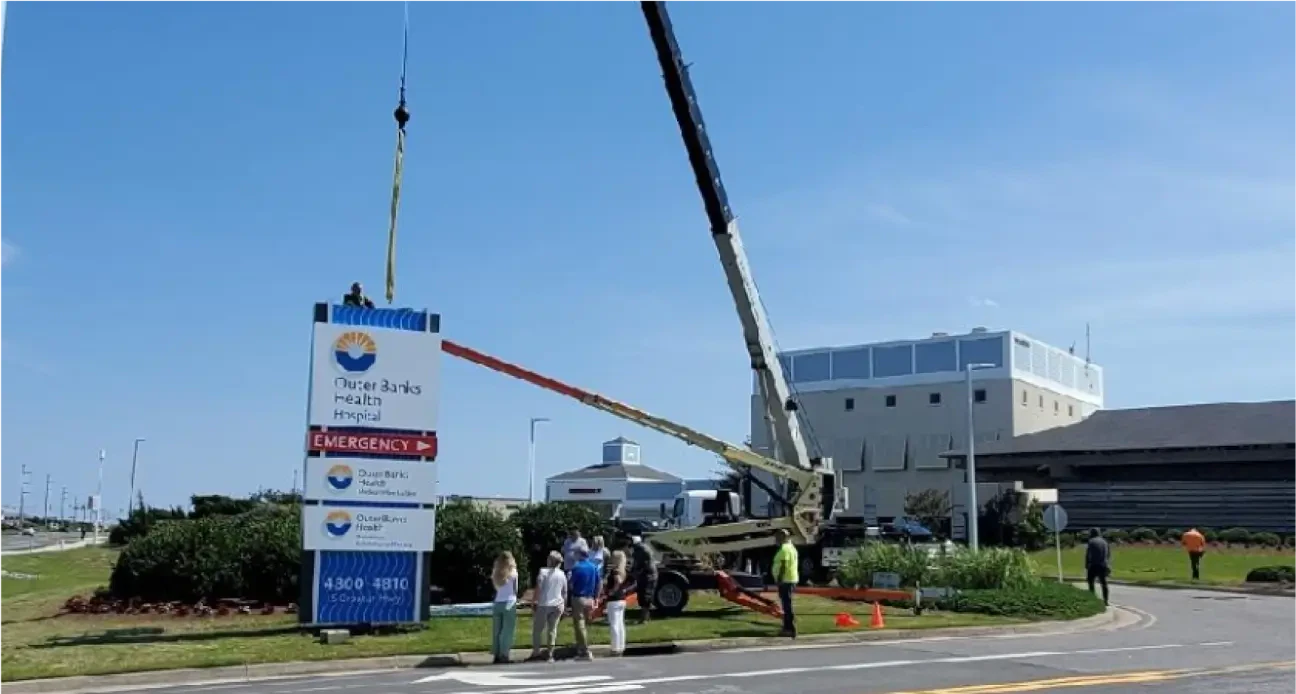 Crane lifting a backyard pool in the Outer Banks
