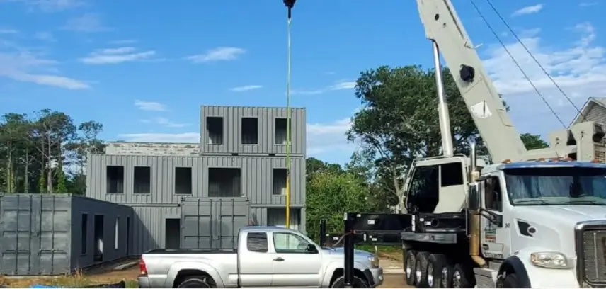 Warehouse crane lifting heavy equipment at a commercial facility in Kitty Hawk, NC